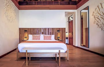 a bed with a wood headboard in a room