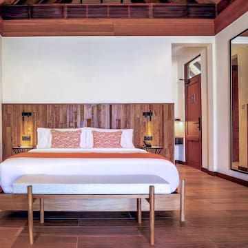 a bed with a wood headboard in a room