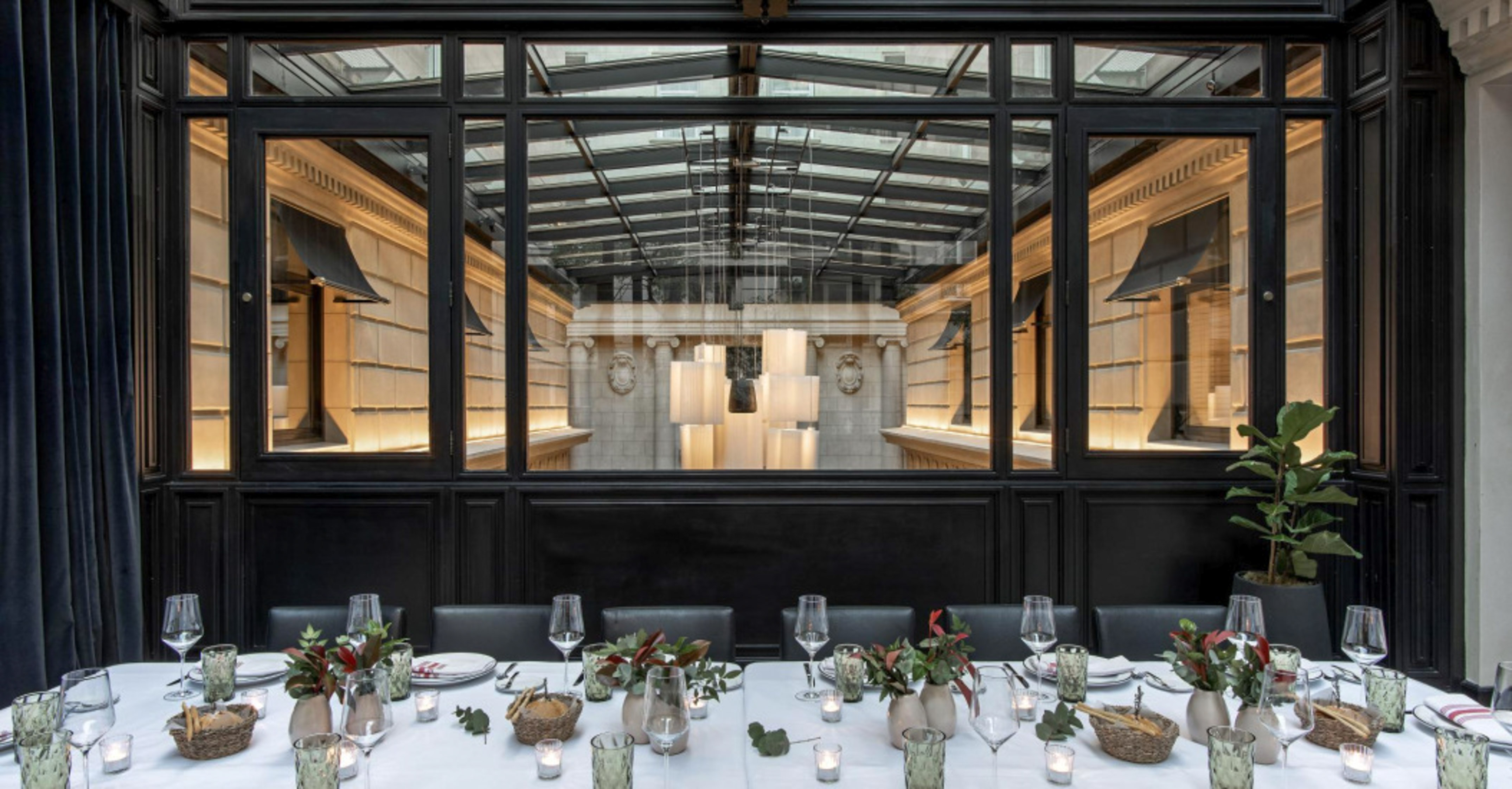 Elegant restaurant dining table with view of ornate architectural interior.