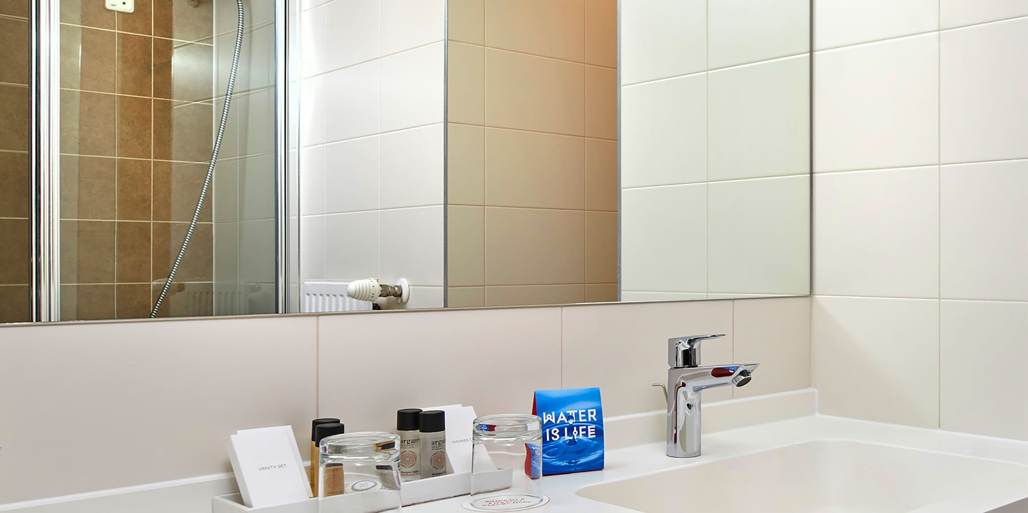 a bathroom with a mirror and sink