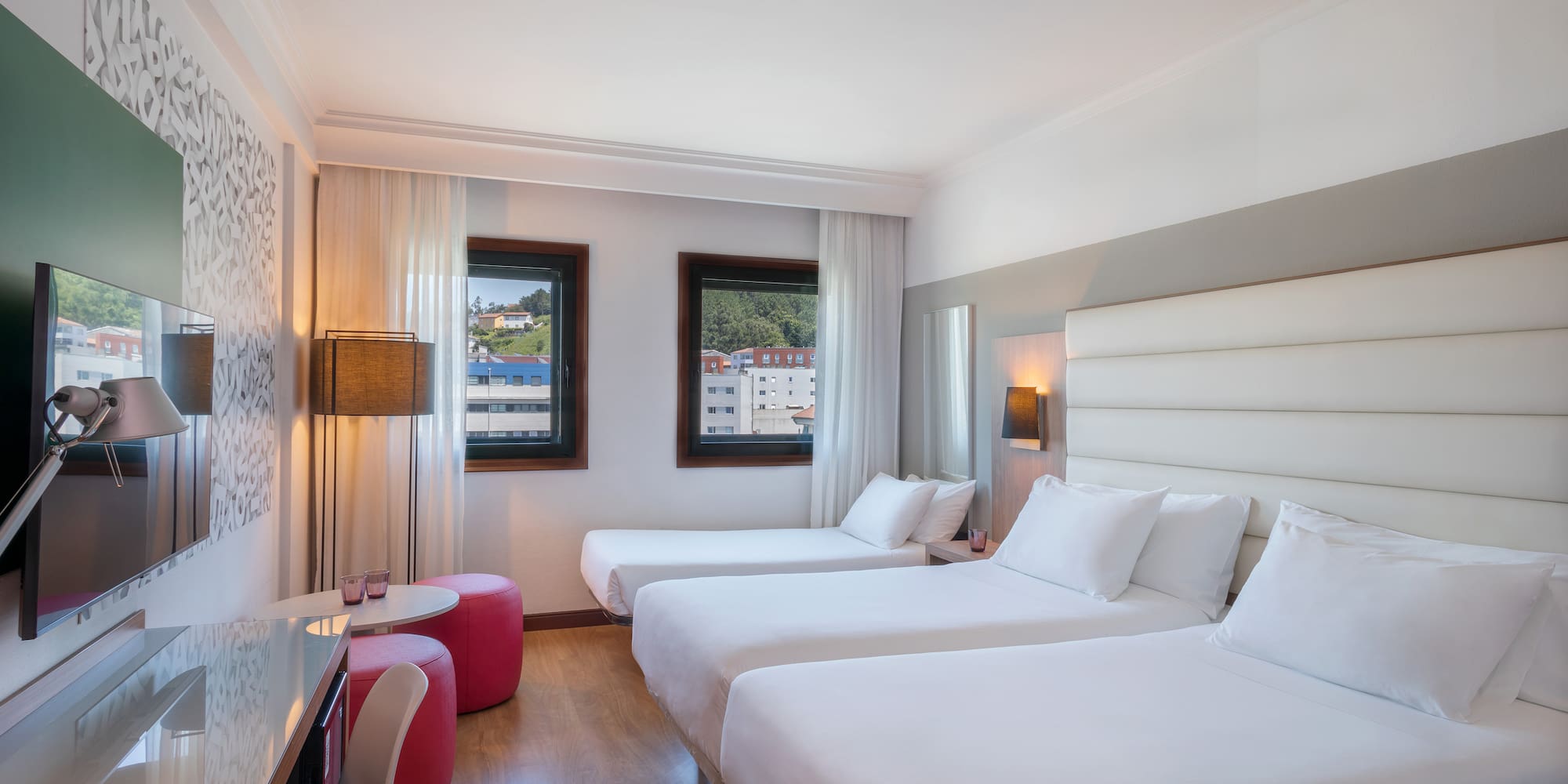 a room with two beds and a table