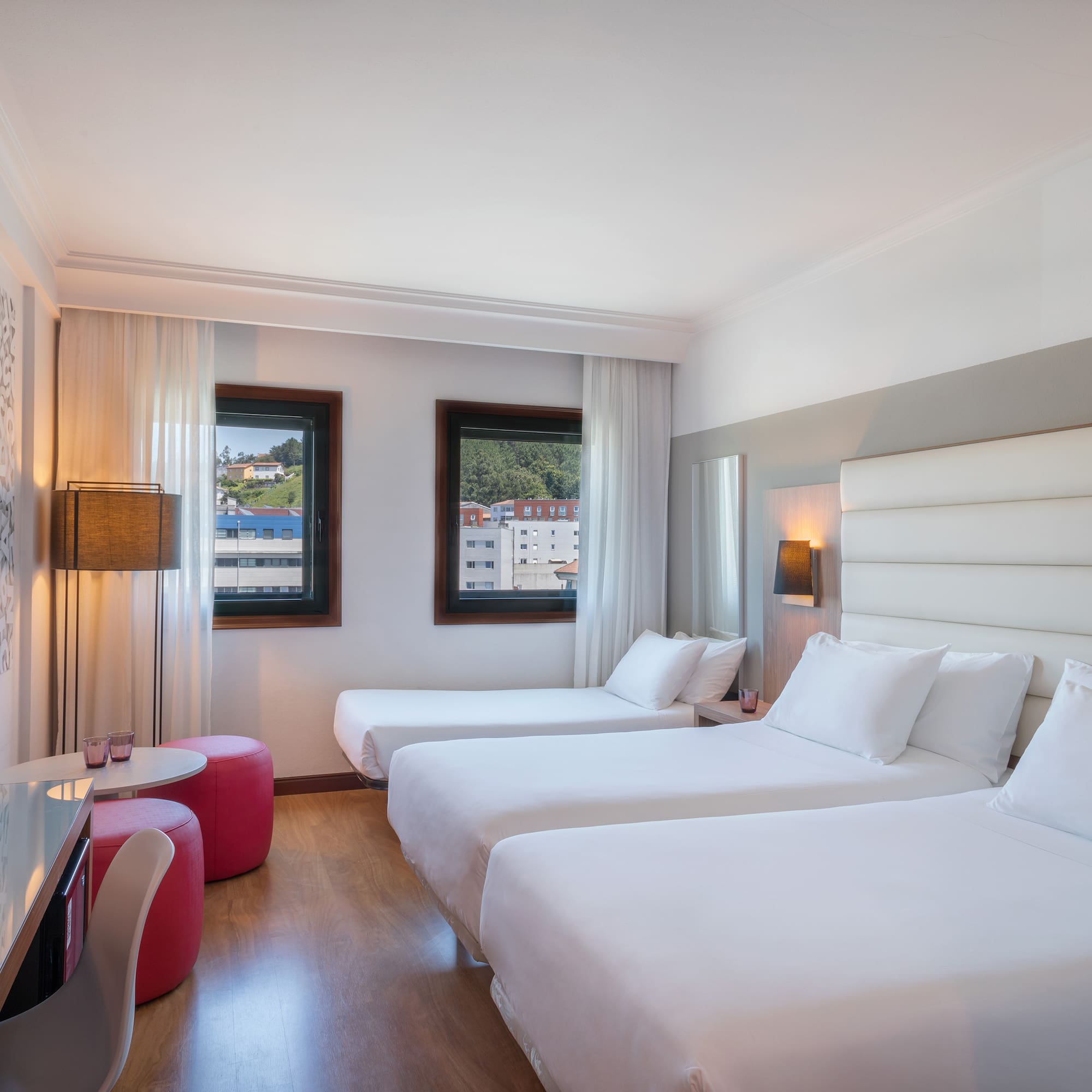 a room with two beds and a table