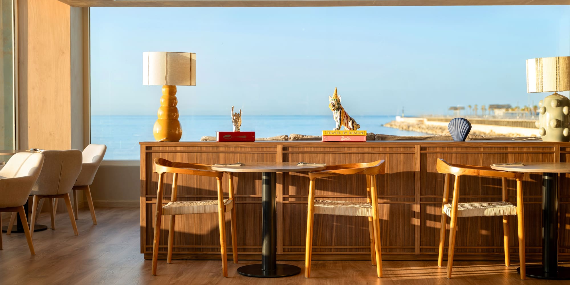 a room with a table and chairs and a large window