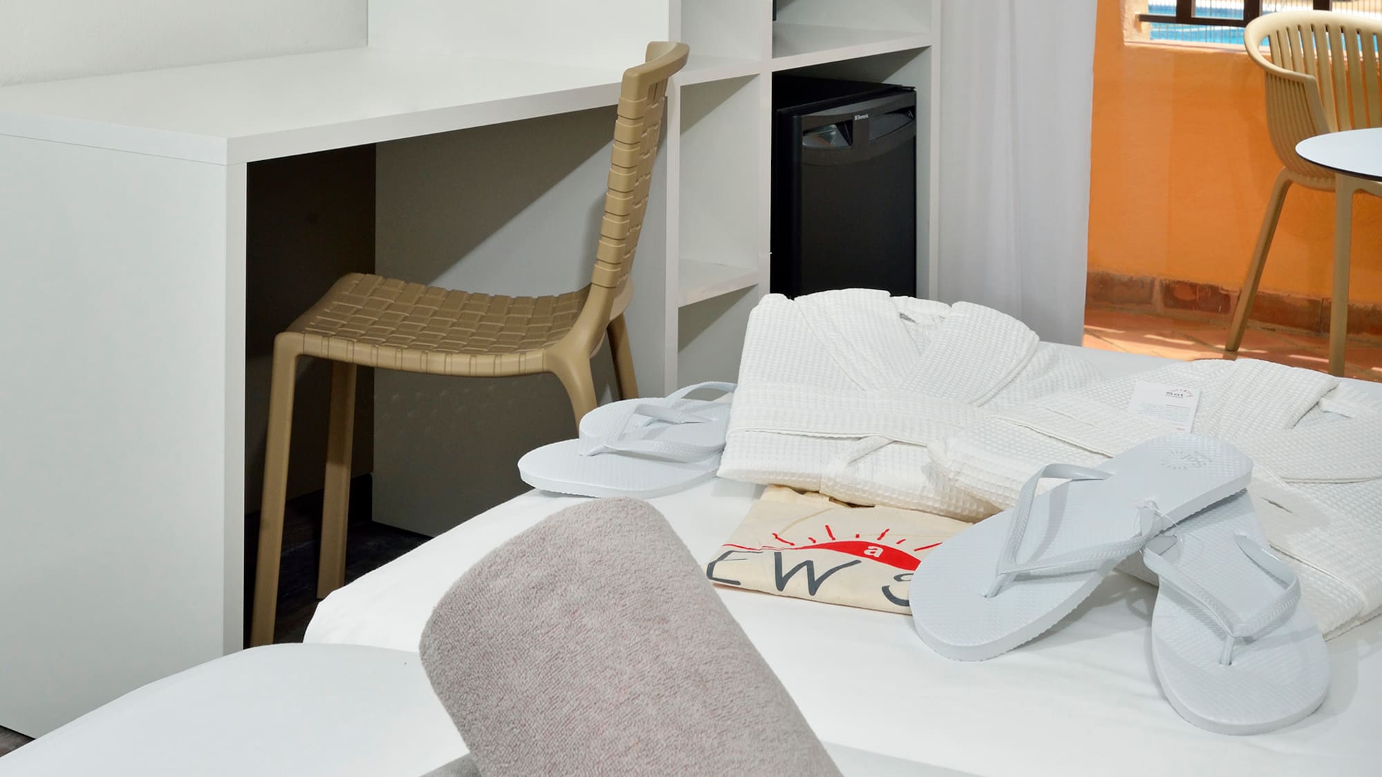 a room with a bed and towels