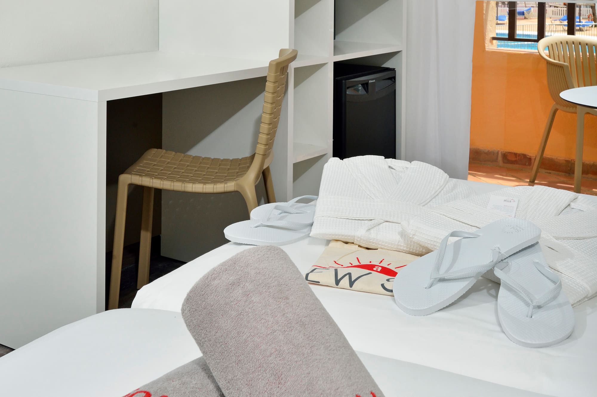 a room with a bed and towels