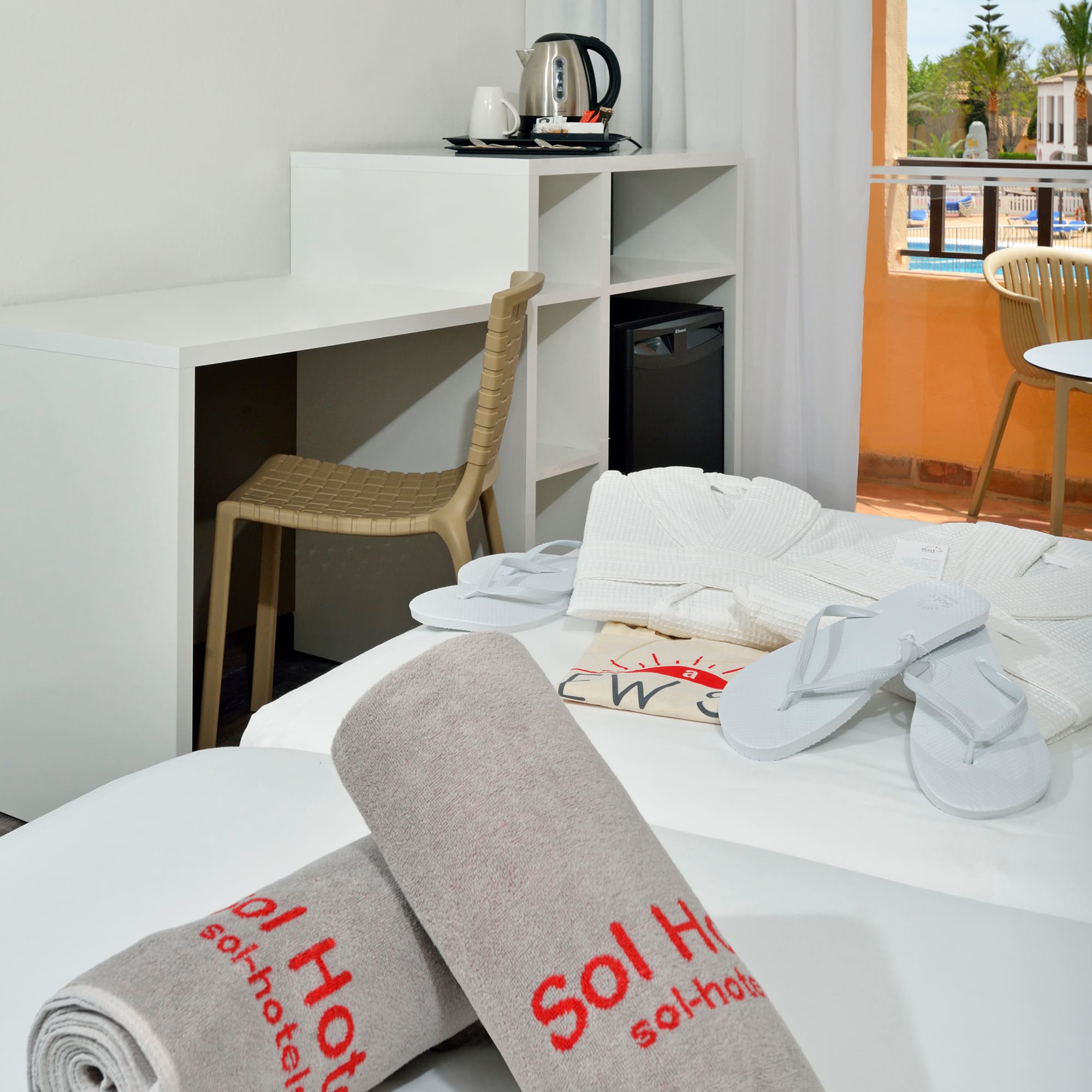 a room with a bed and towels