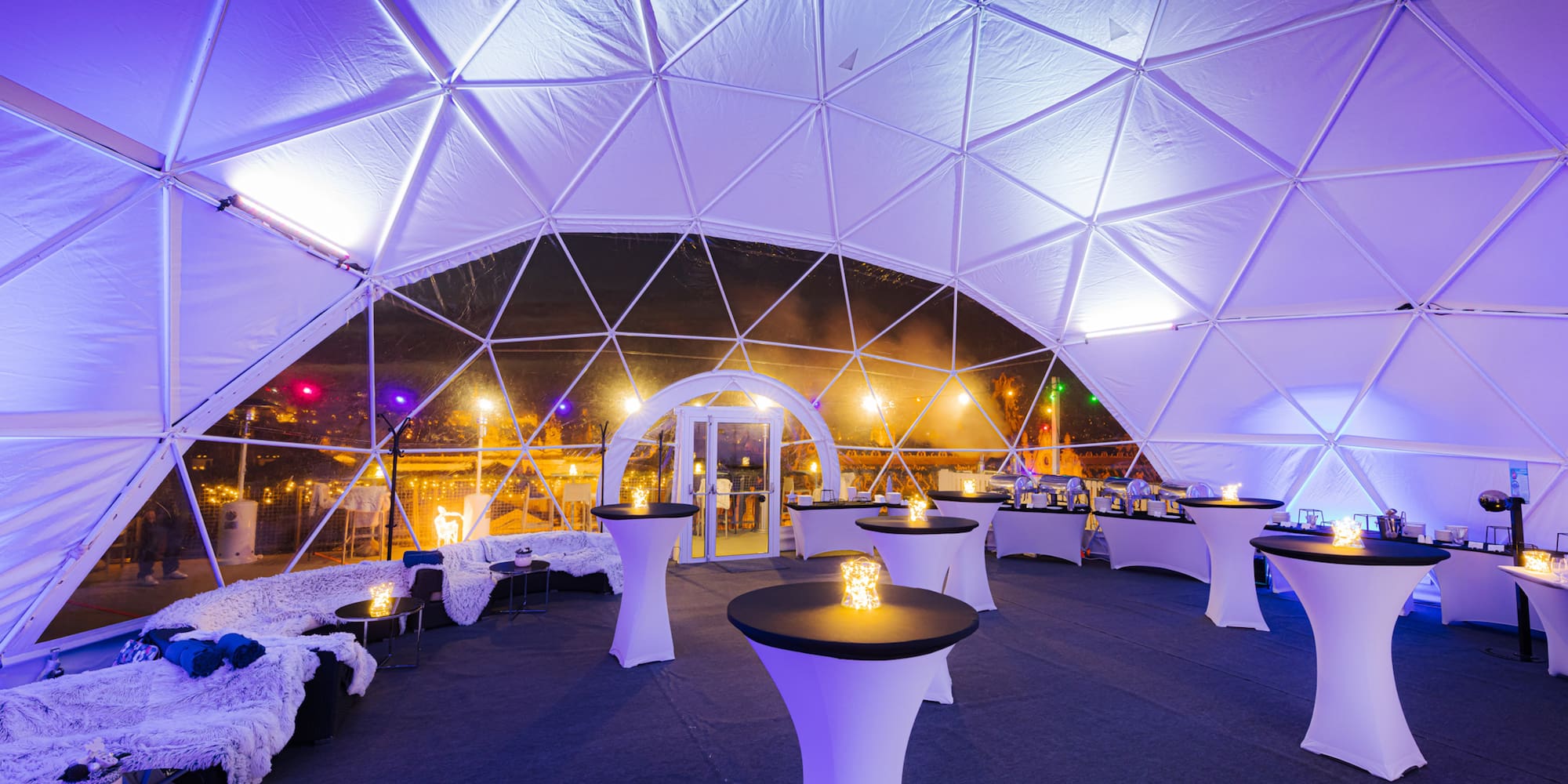 a white tent with tables and chairs