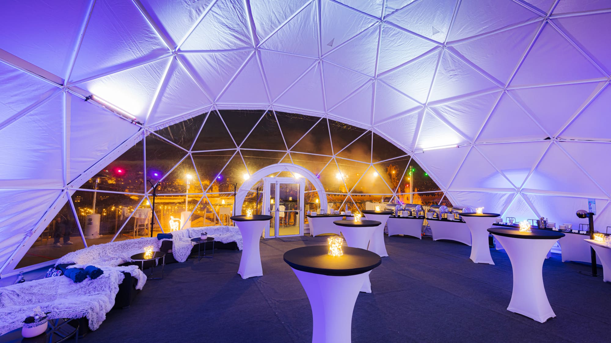 a white tent with tables and chairs