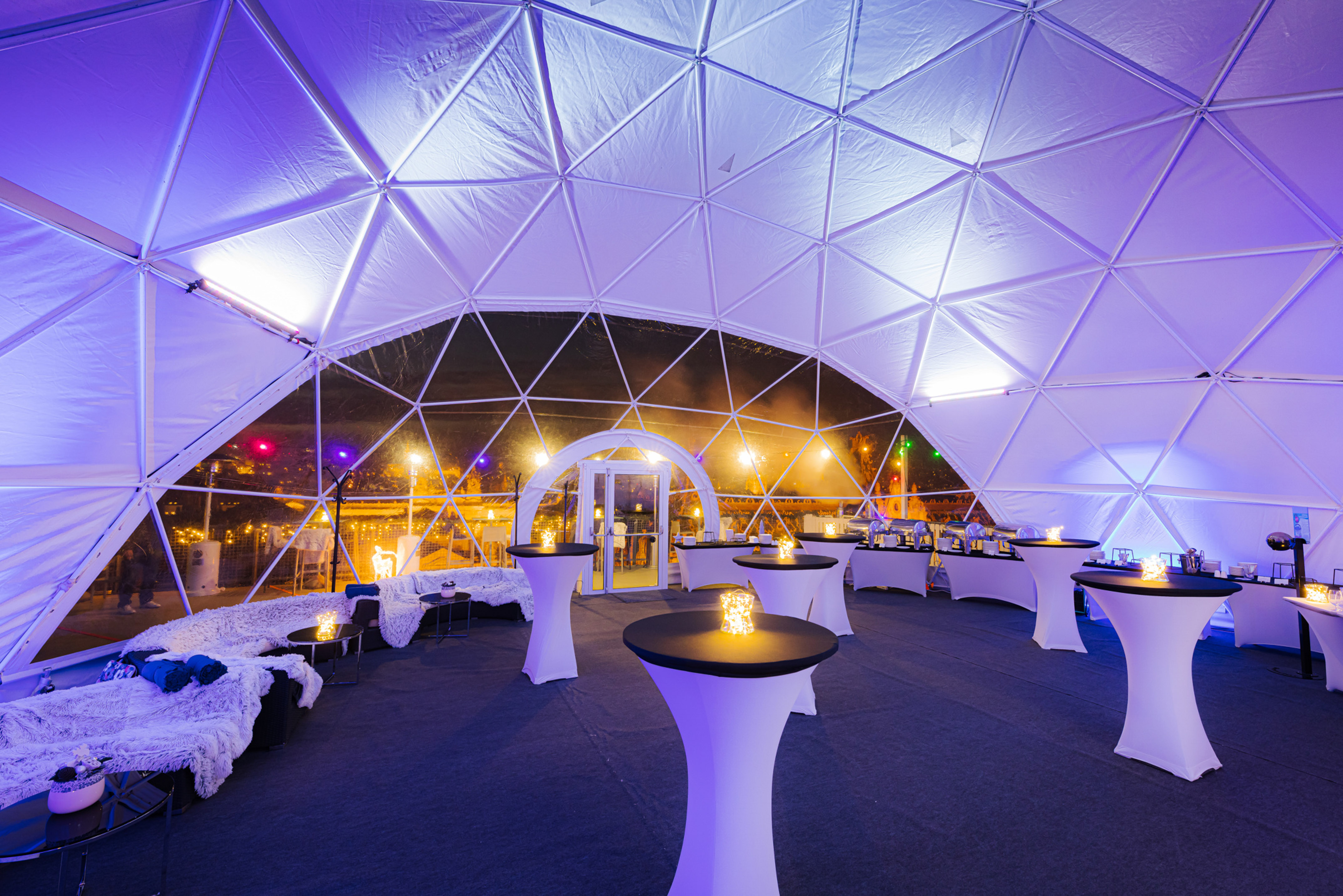 a white tent with tables and chairs