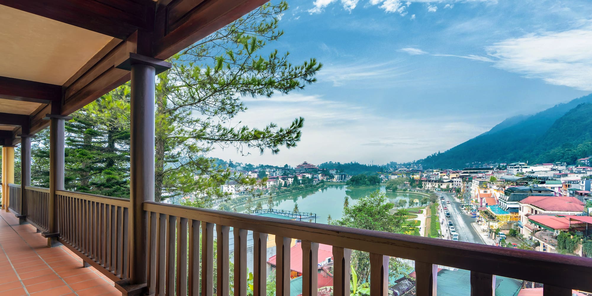 a balcony with a view of a city and a river