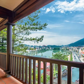 a balcony with a view of a city and a river