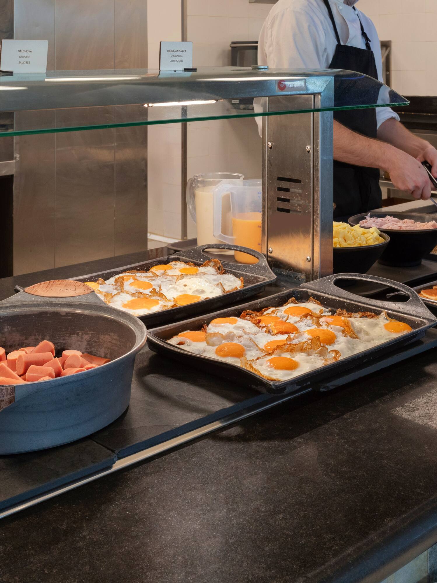 a person cooking breakfast in a kitchen
