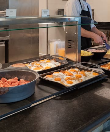 a person cooking breakfast in a kitchen