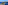 Helicopter flying above a green coastal island with yachts in a blue ocean.