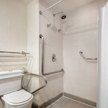 a bathroom with a toilet and a shower