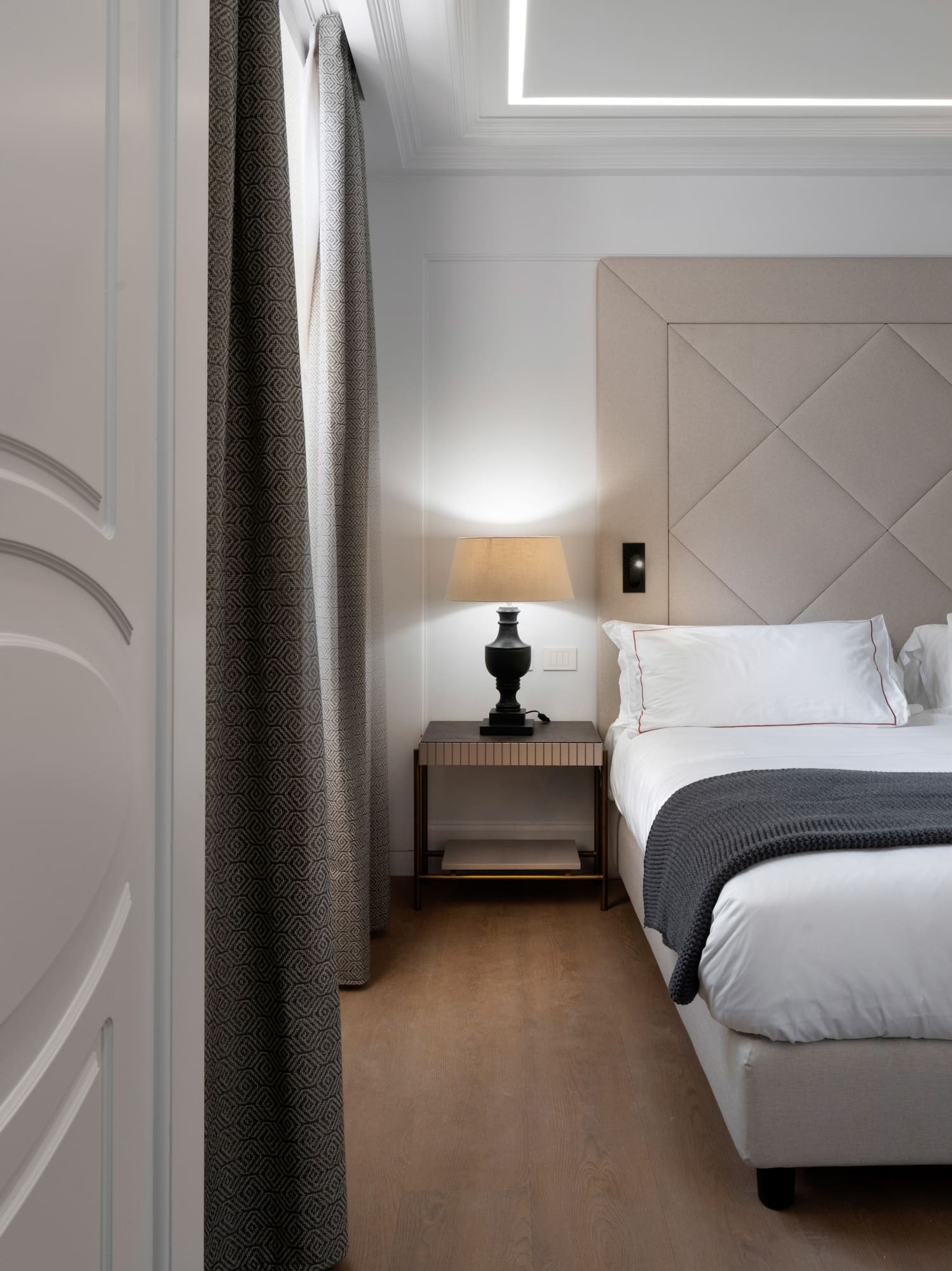 a bedroom with a bed and a lamp