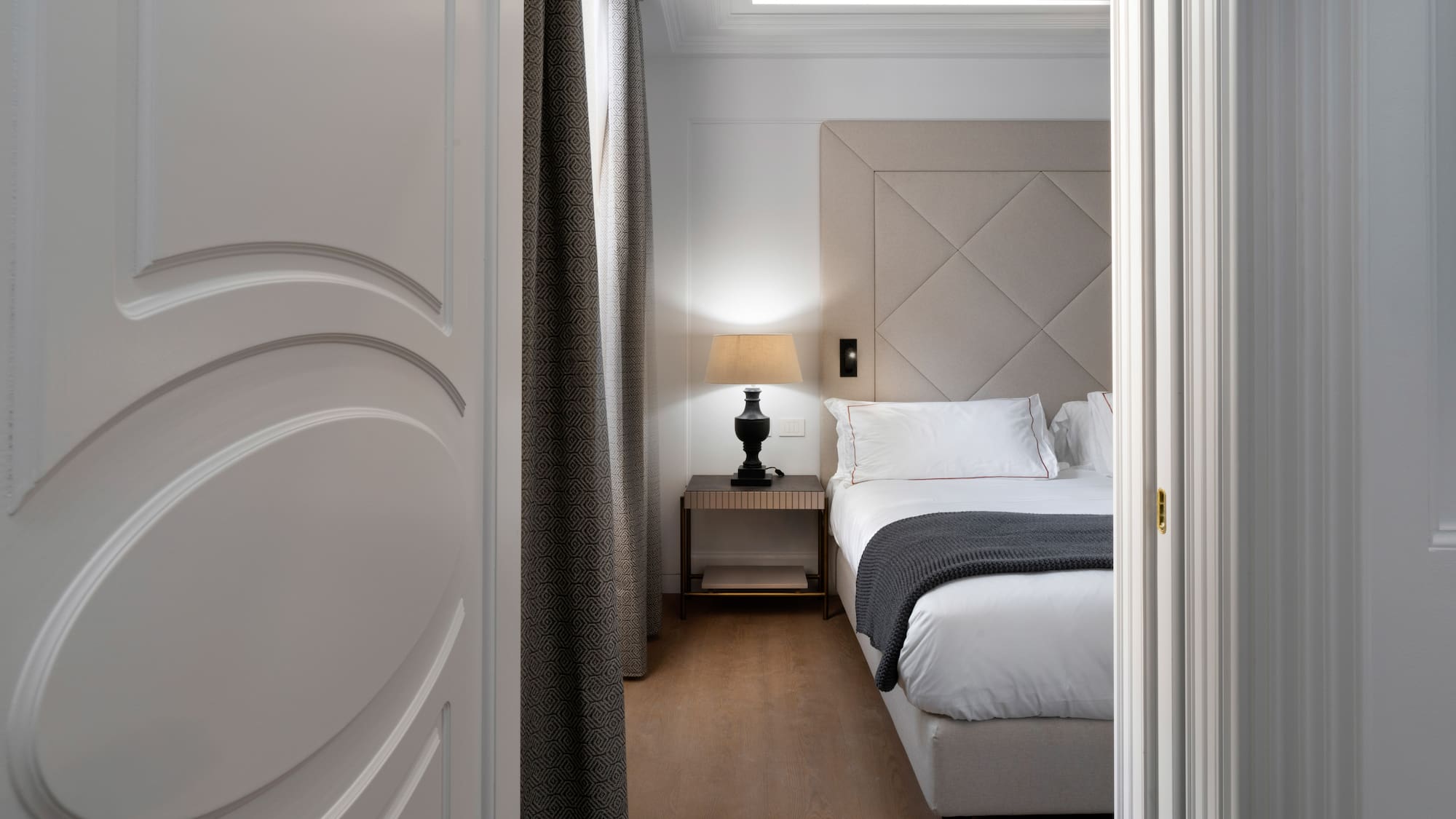 a bedroom with a bed and a lamp