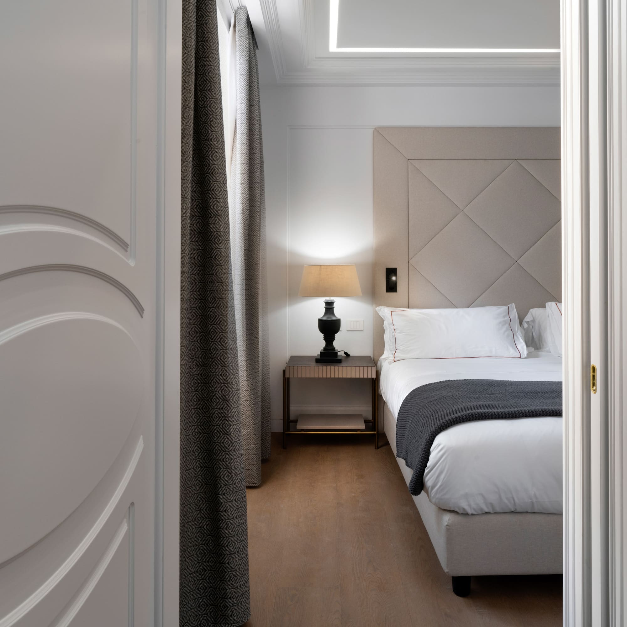 a bedroom with a bed and a lamp