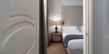 a bedroom with a bed and a lamp