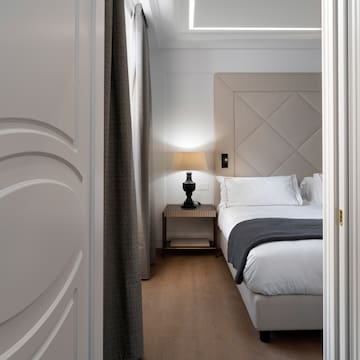 a bedroom with a bed and a lamp