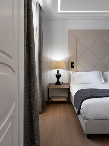 a bedroom with a bed and a lamp