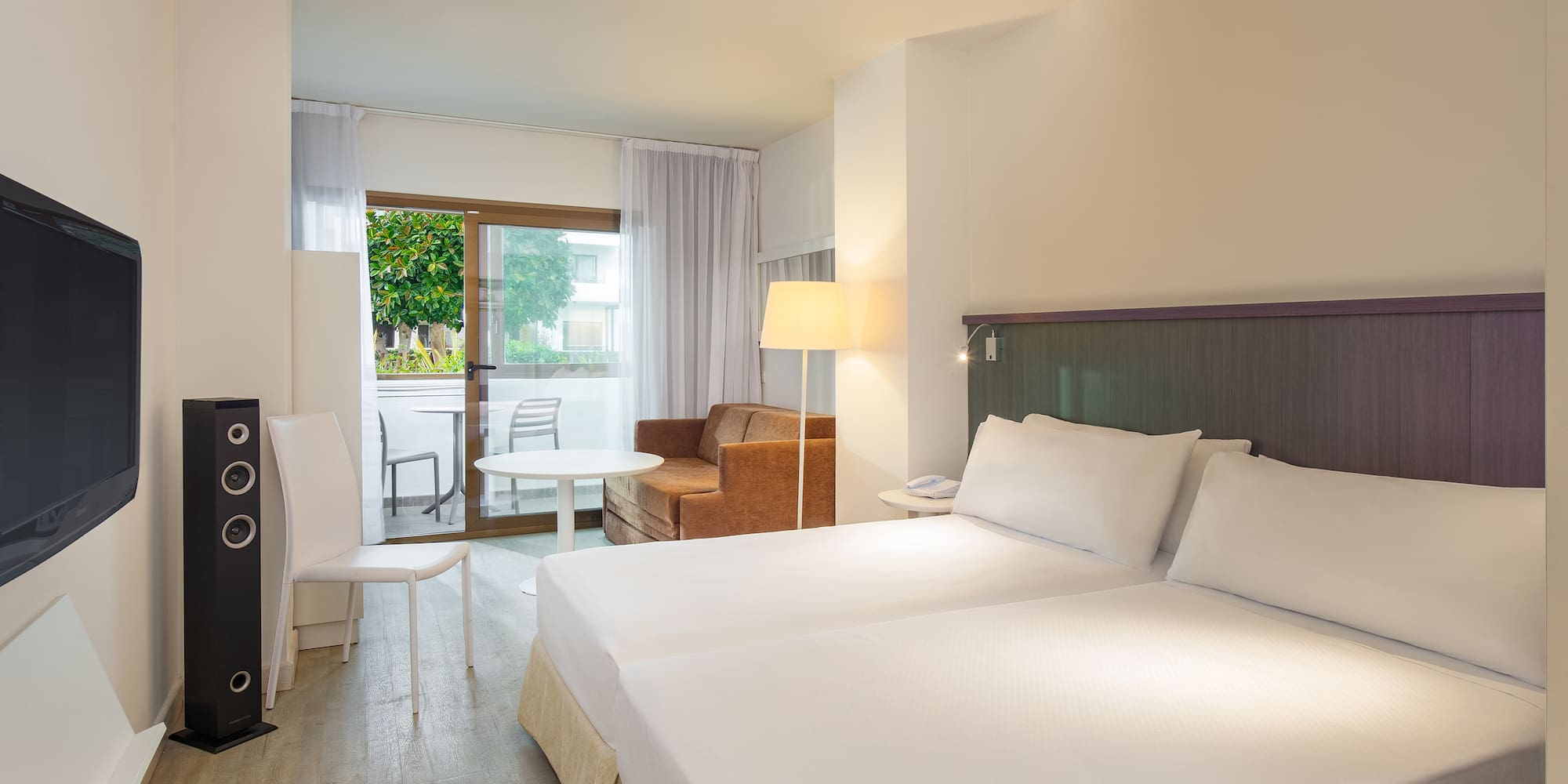 a room with two beds and a table