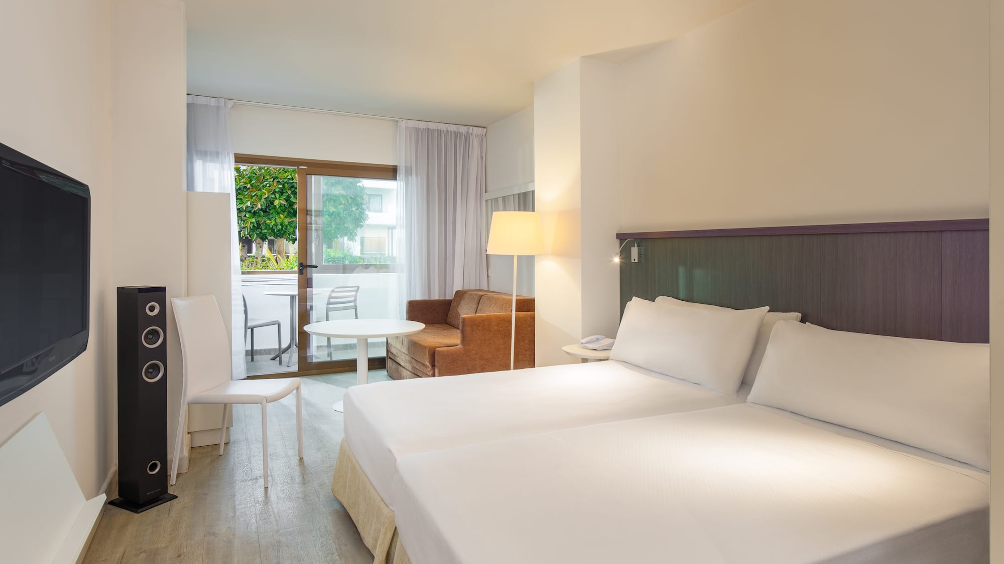 a room with two beds and a table