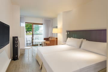 a room with two beds and a table