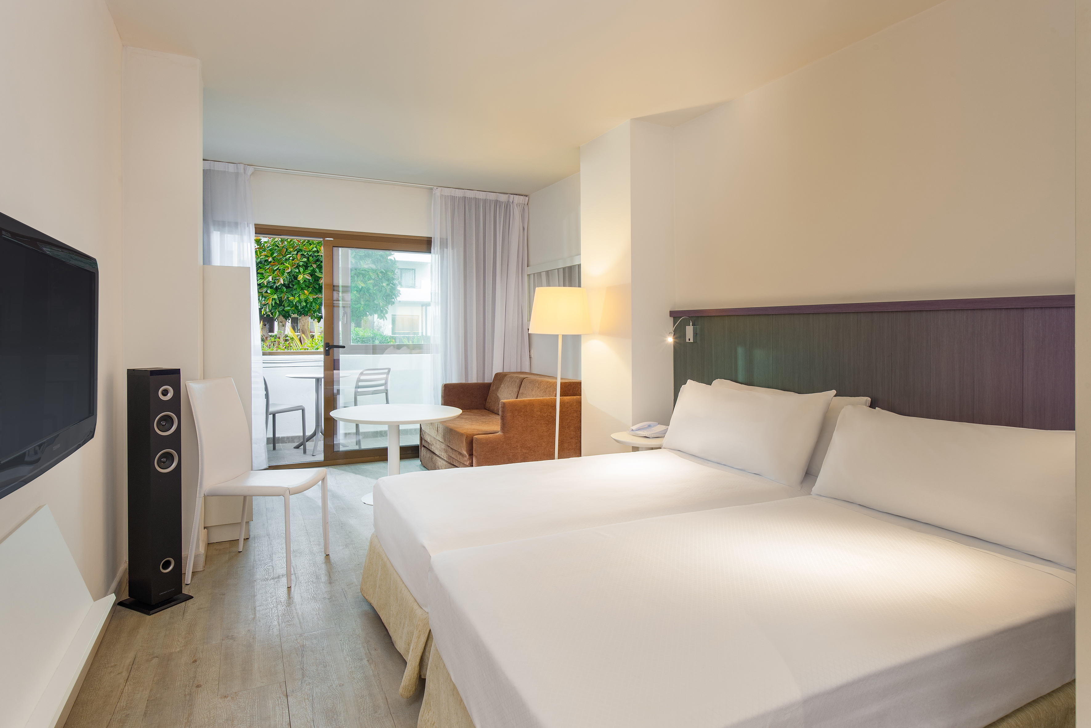 a room with two beds and a table