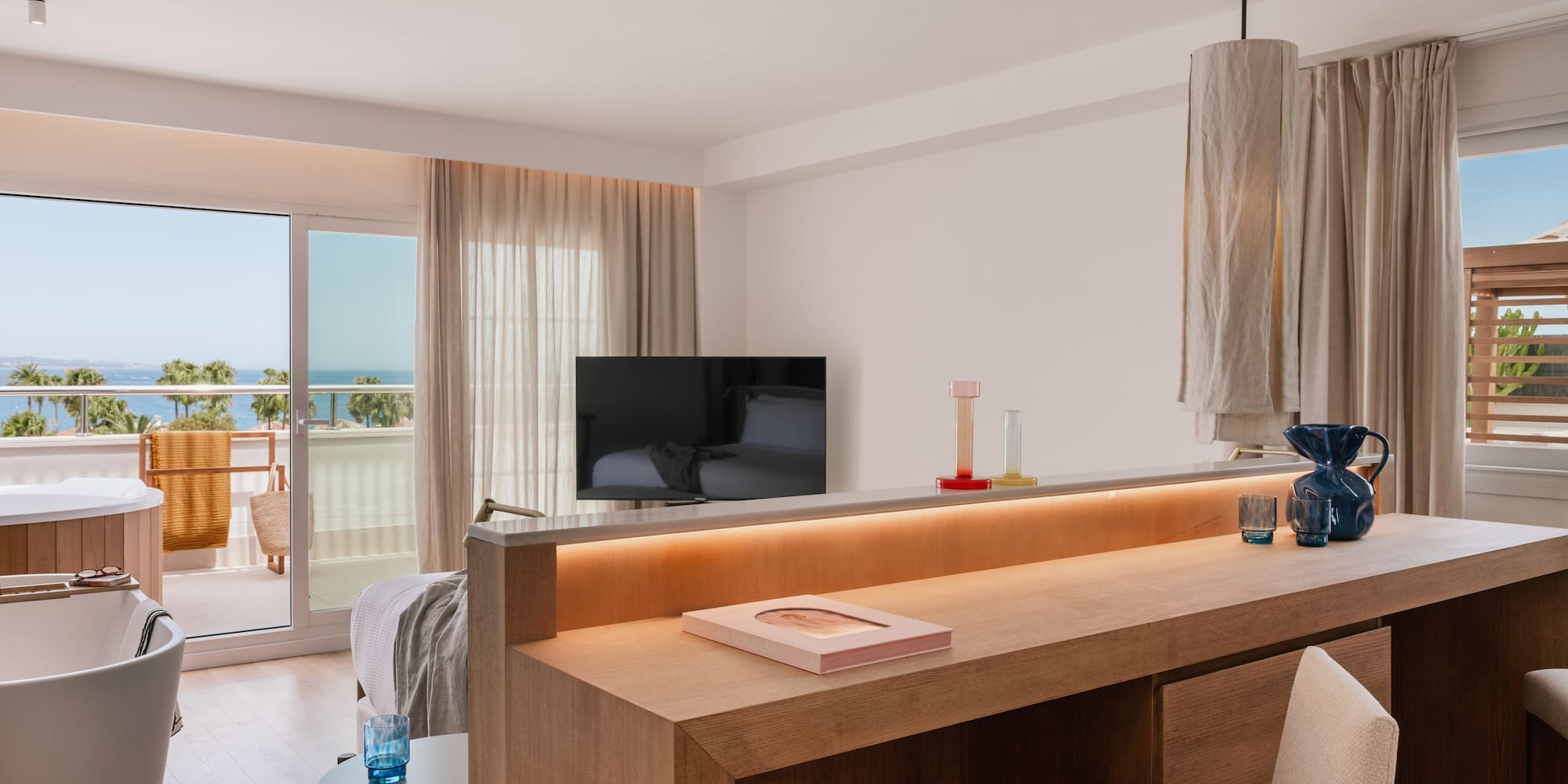 a room with a television and a balcony