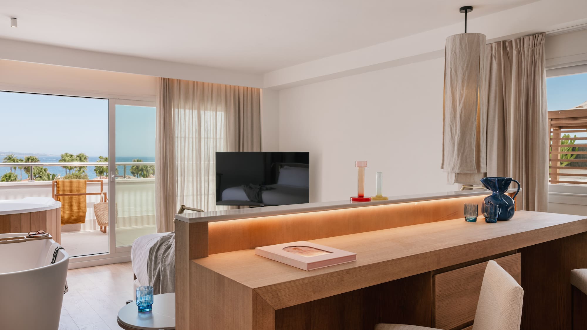 a room with a television and a balcony