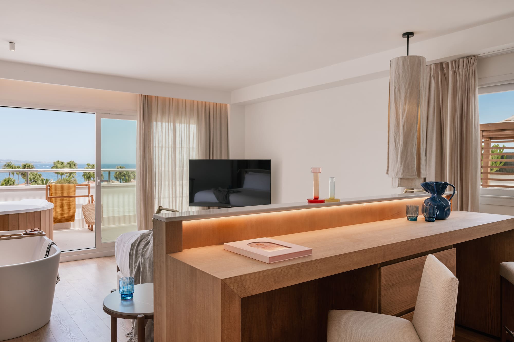 a room with a television and a balcony