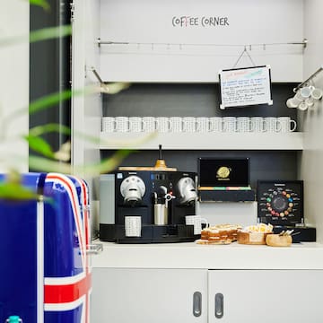 a coffee machine and cupcakes on a counter