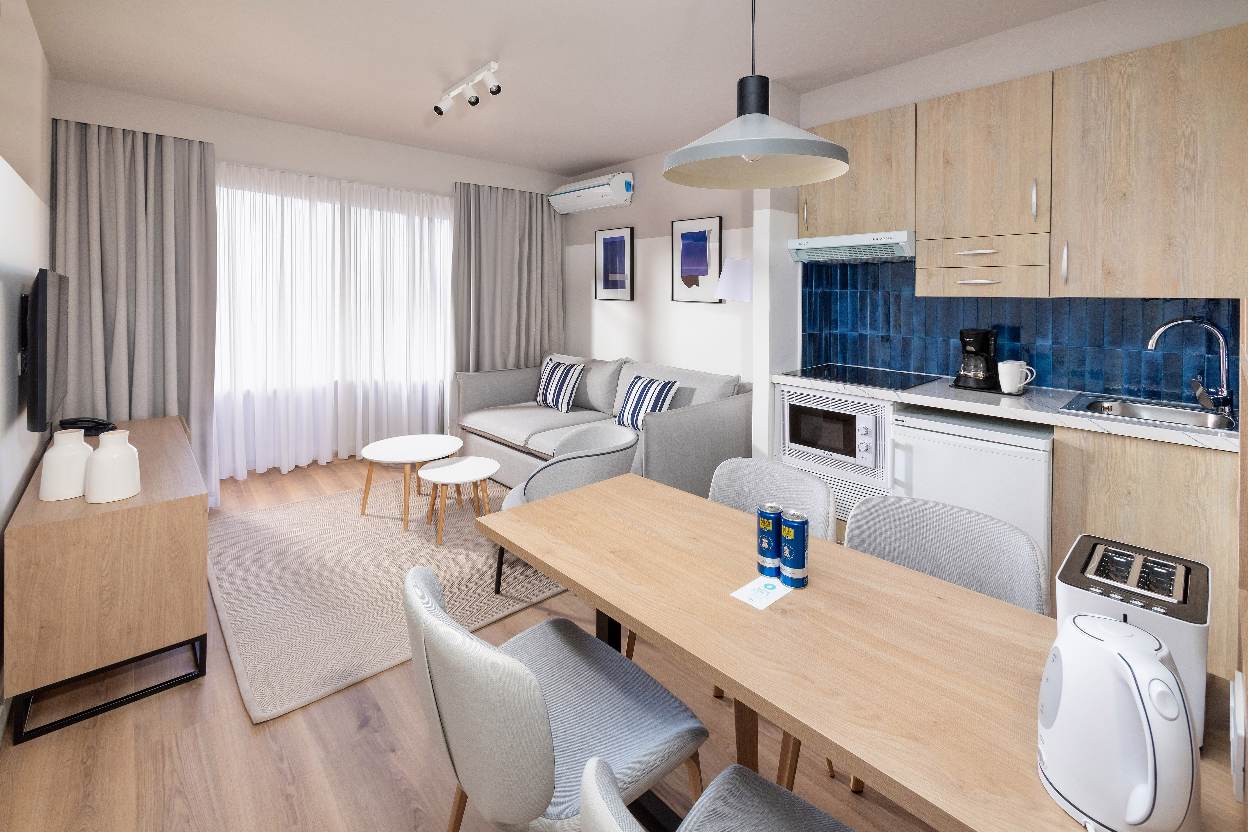 Modern studio apartment: living room, dining area, compact kitchen.