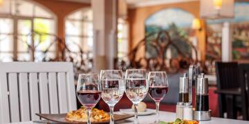 a table with plates of food and wine glasses