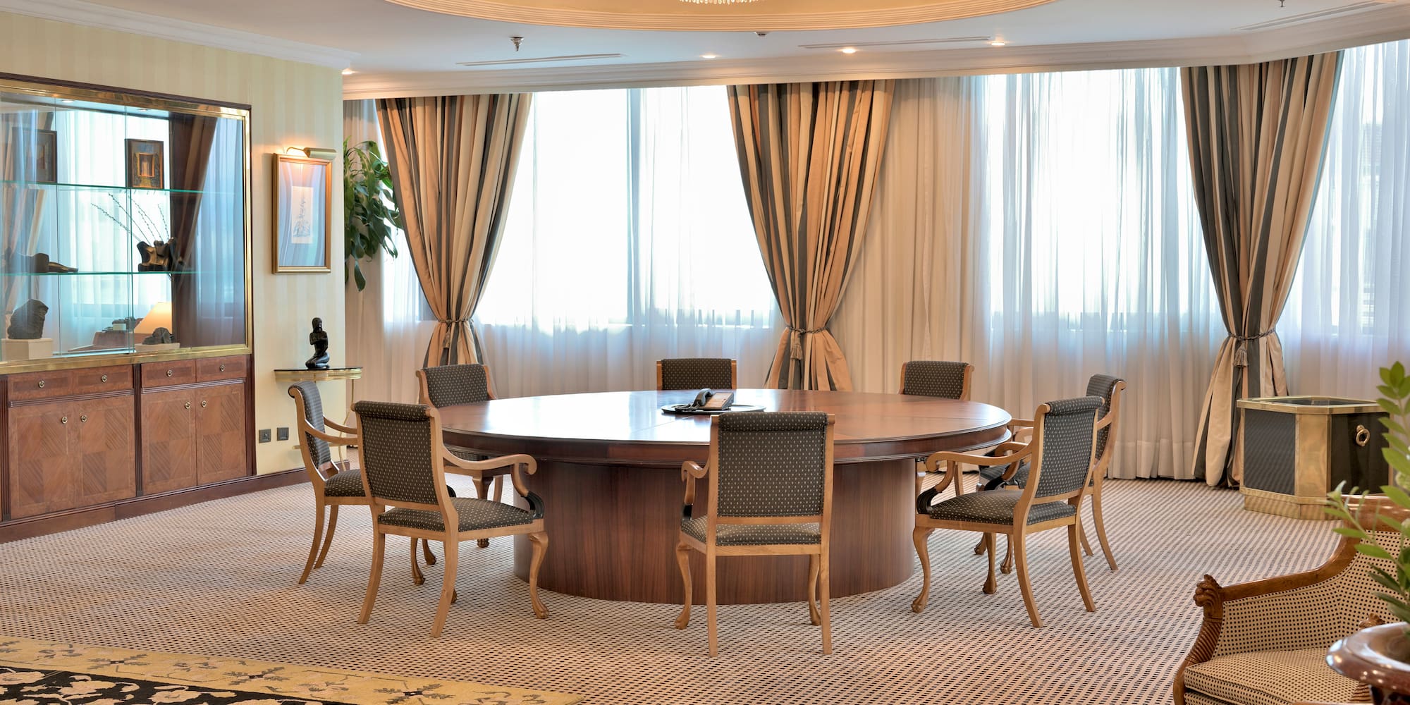 a room with a round table and chairs