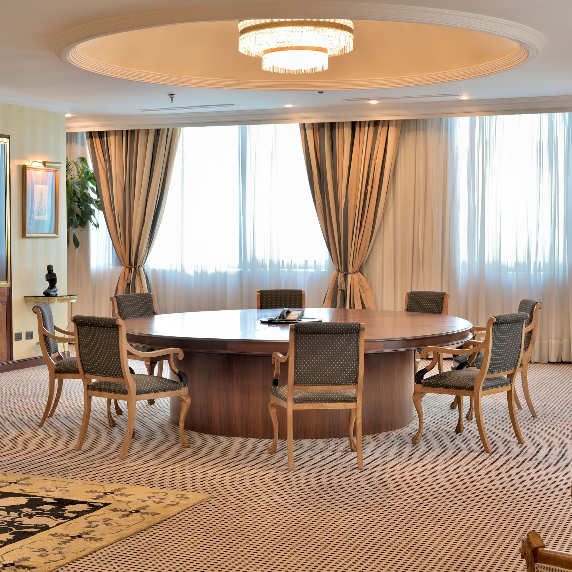 a room with a round table and chairs
