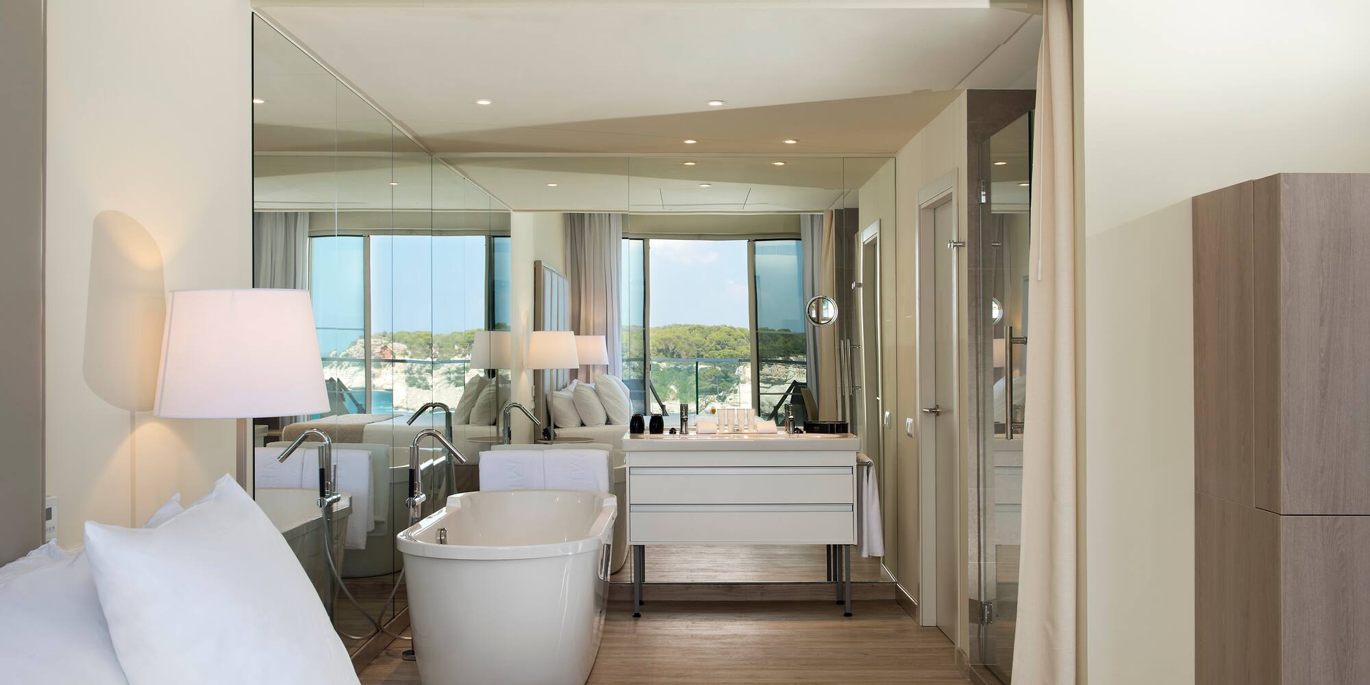 a room with a bathtub and a mirror