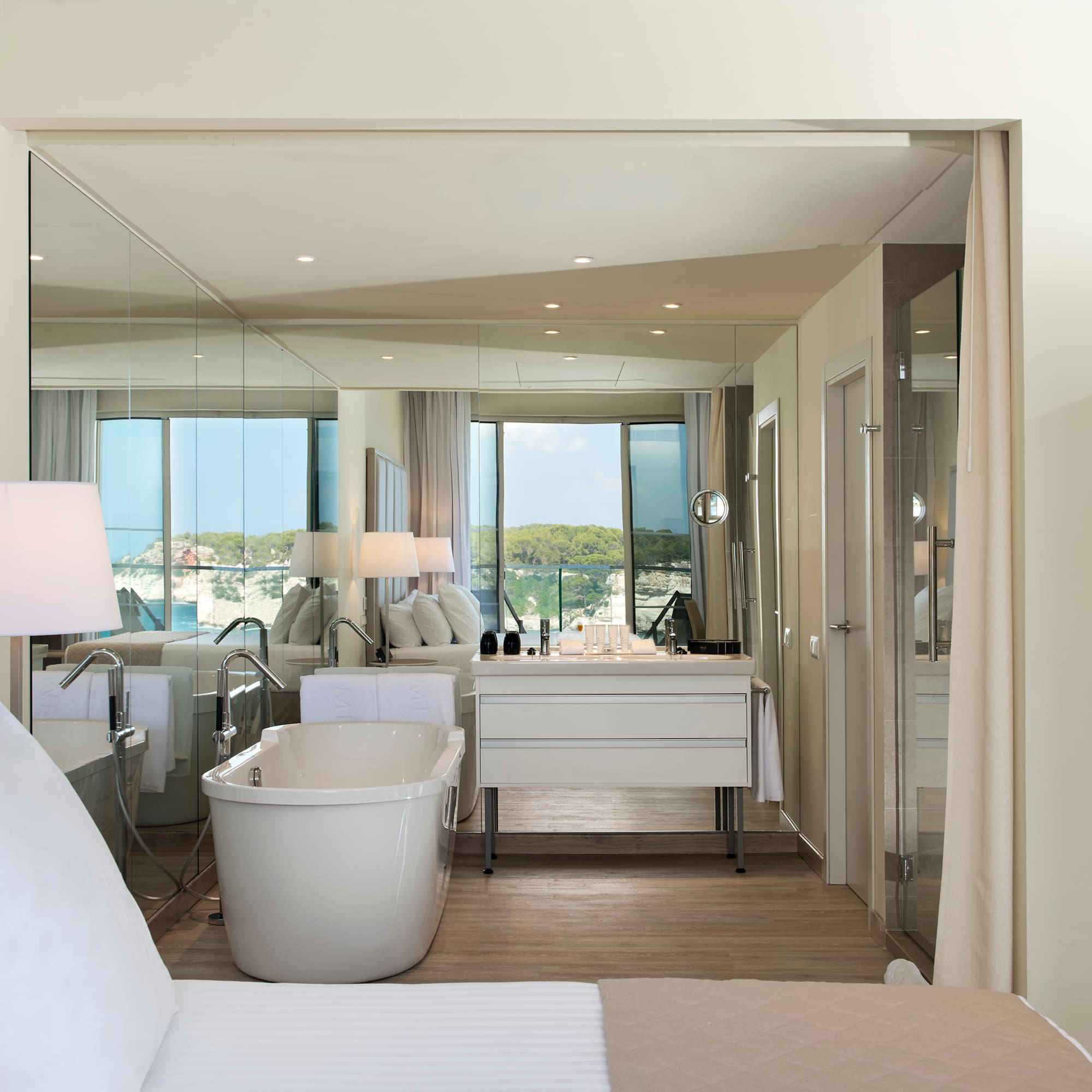 a room with a bathtub and a mirror