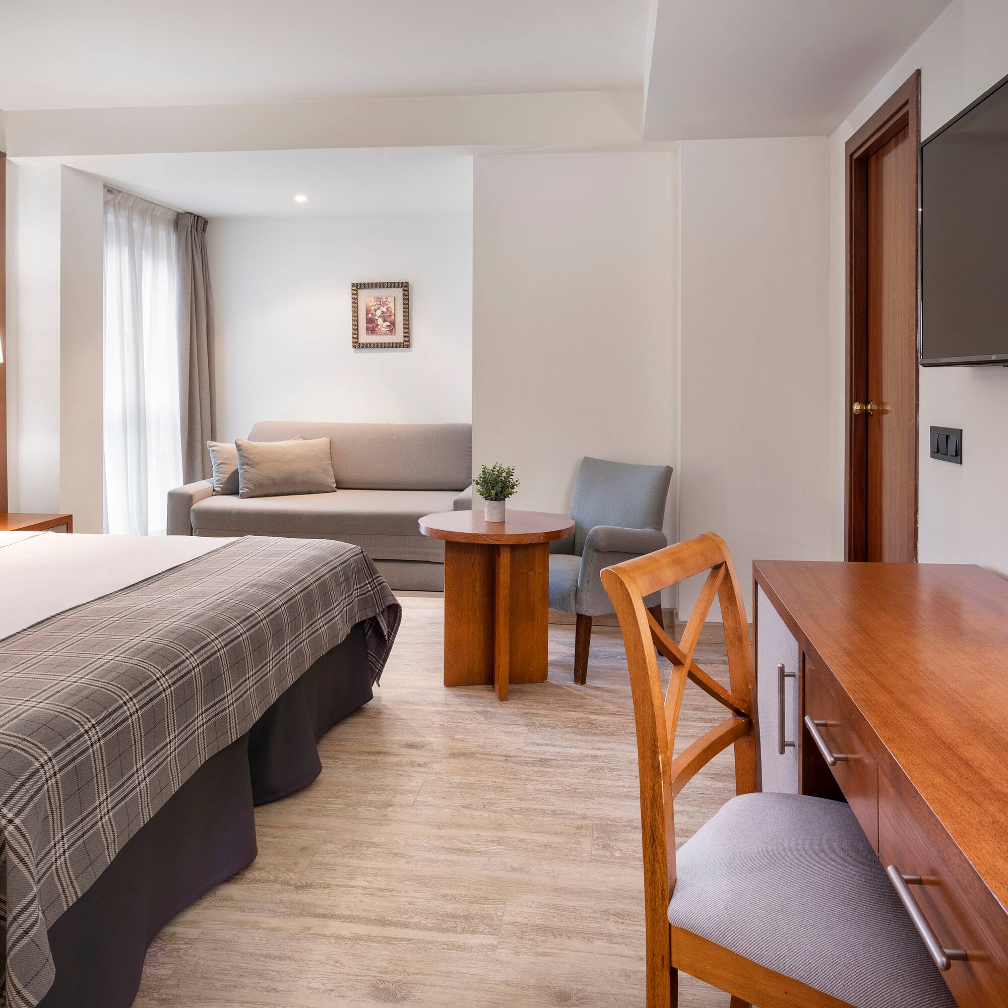 a room with a bed and a television