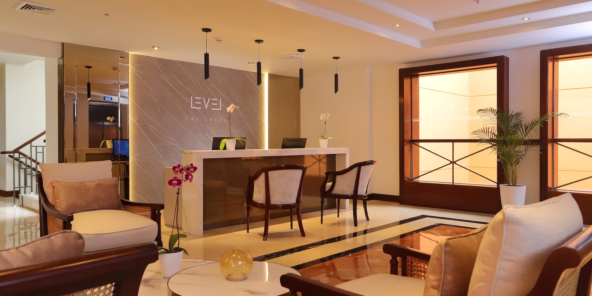 a lobby with a reception desk and chairs
