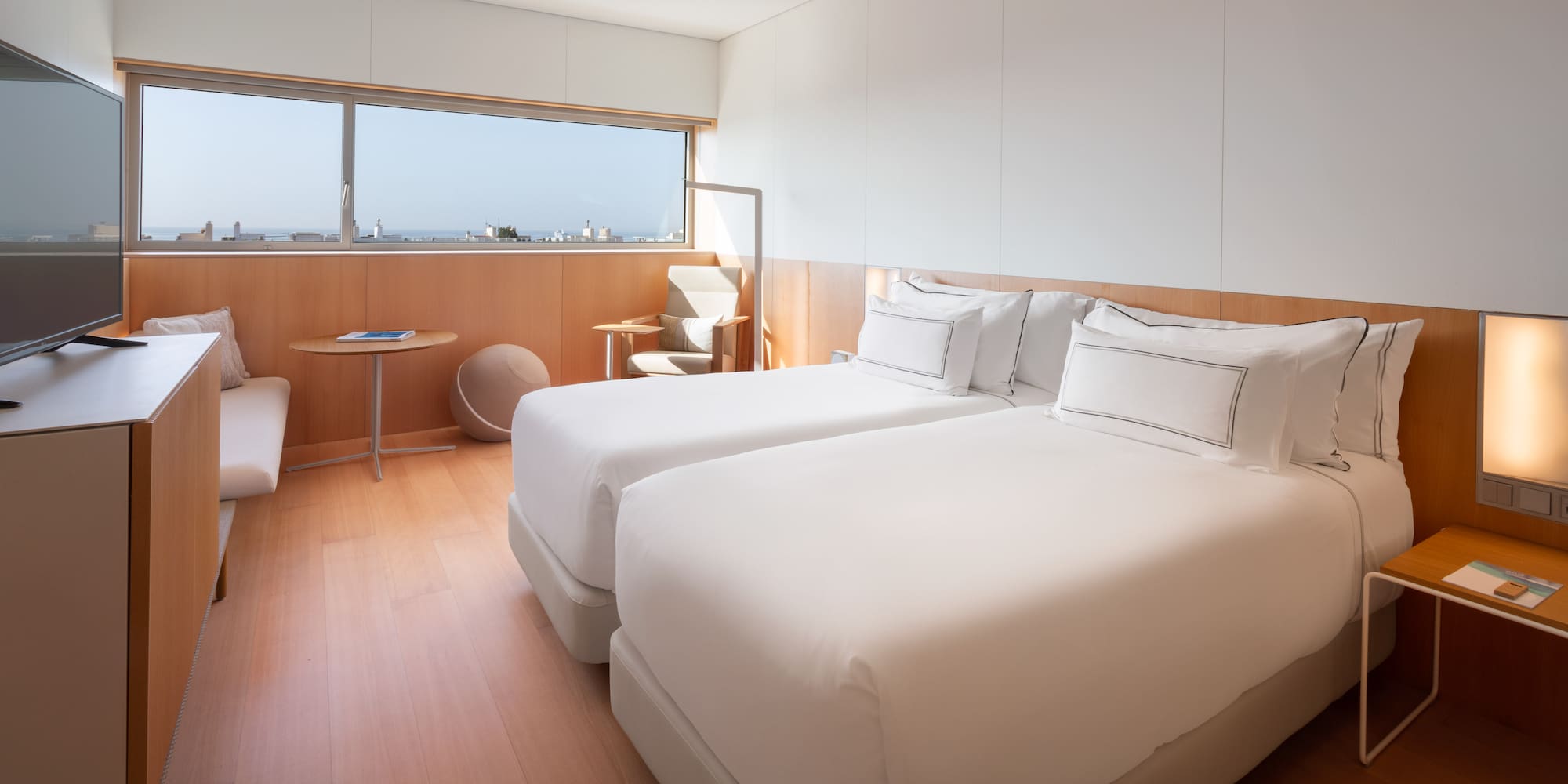 a room with two beds and a window