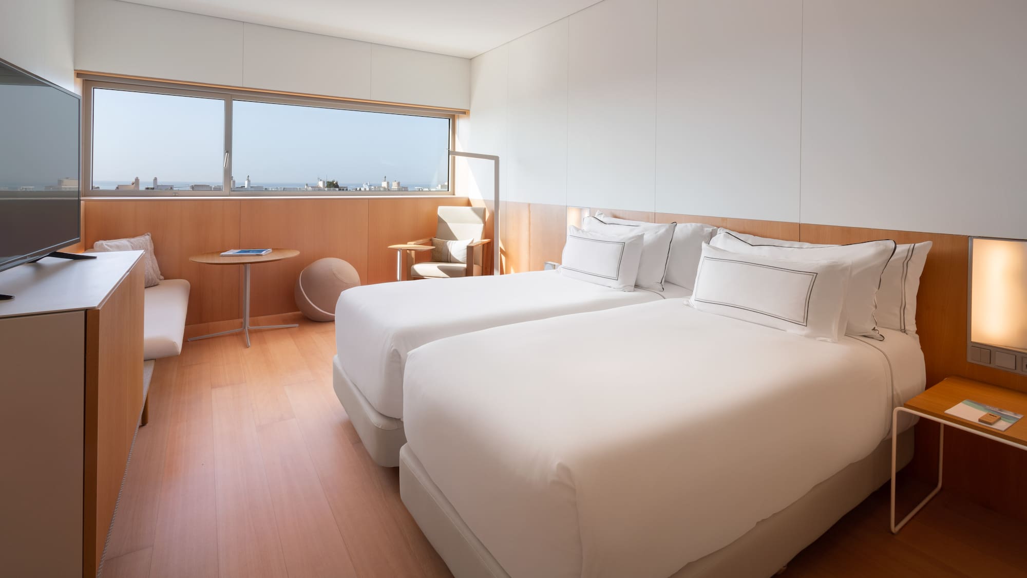 a room with two beds and a window