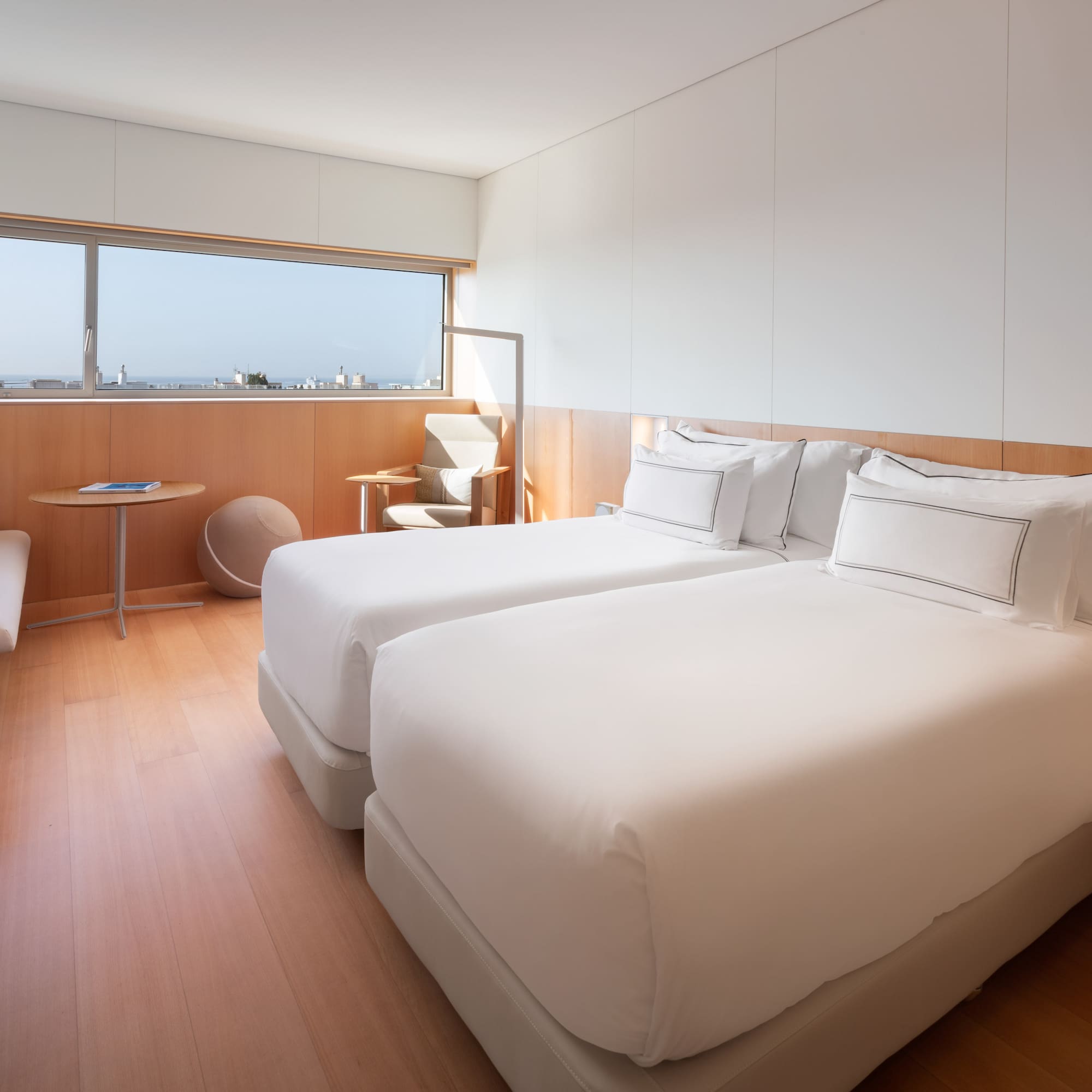 a room with two beds and a window