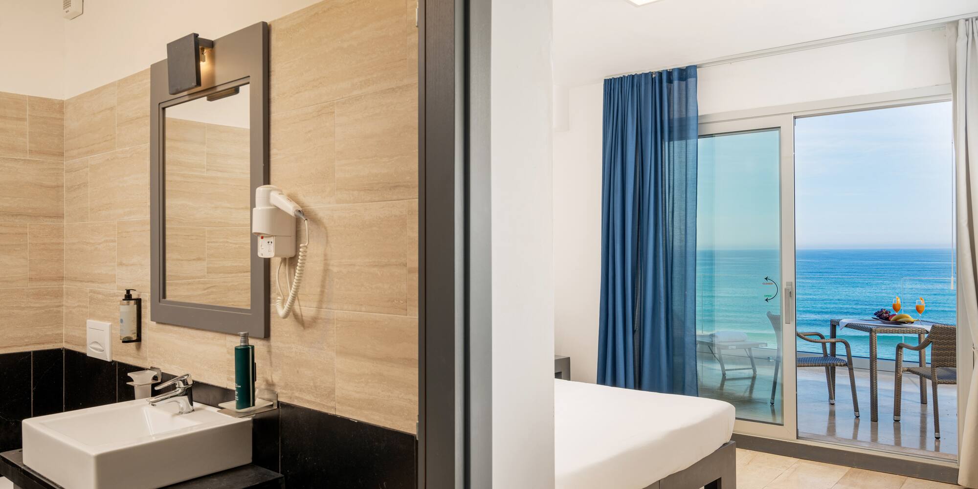 a bathroom with a large window and a bed and a mirror