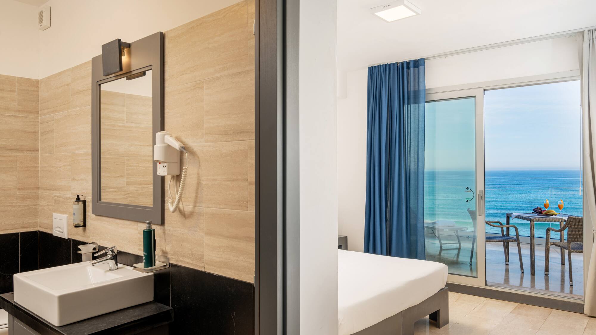 a bathroom with a large window and a bed and a mirror