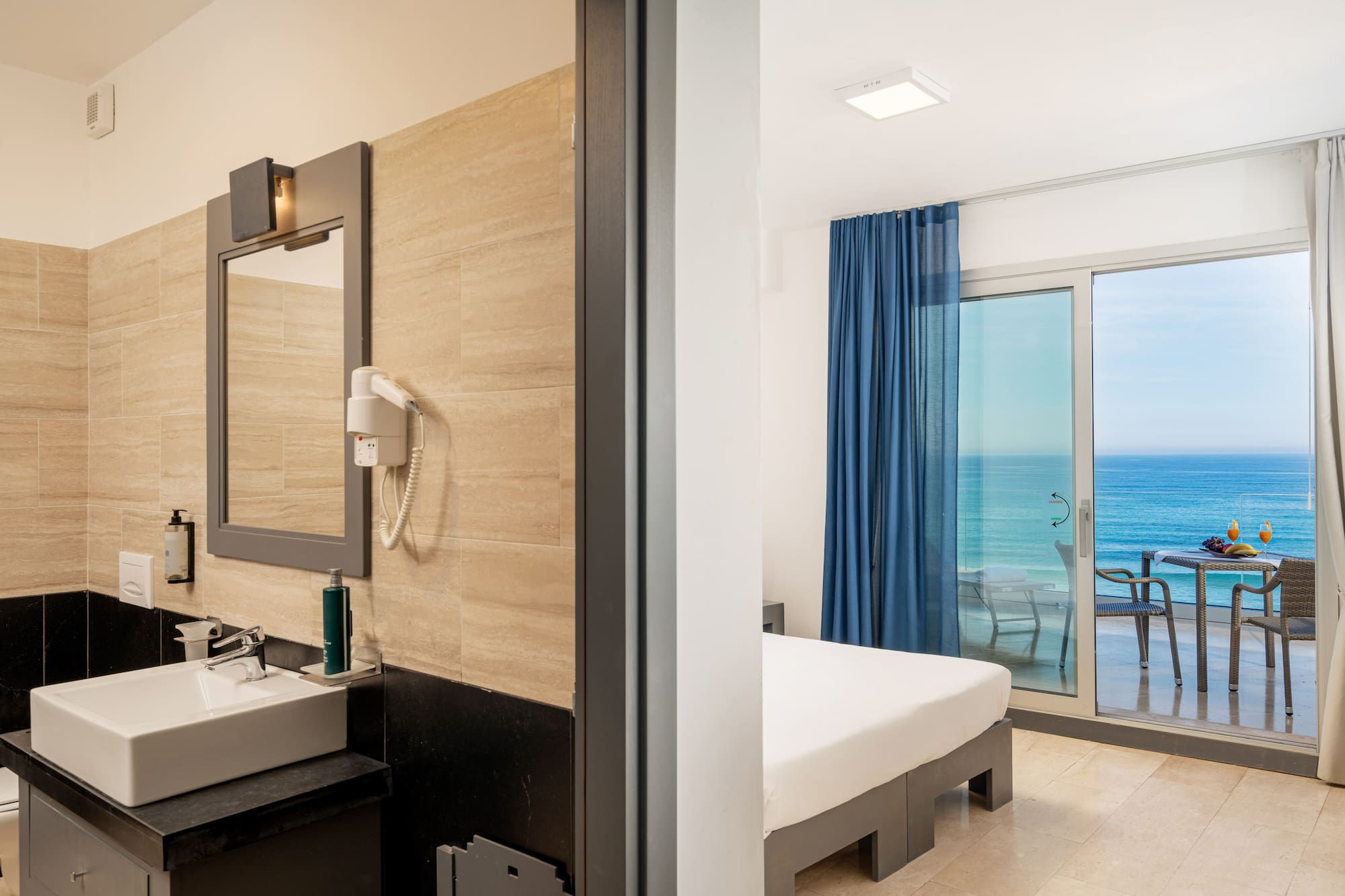 a bathroom with a large window and a bed and a mirror