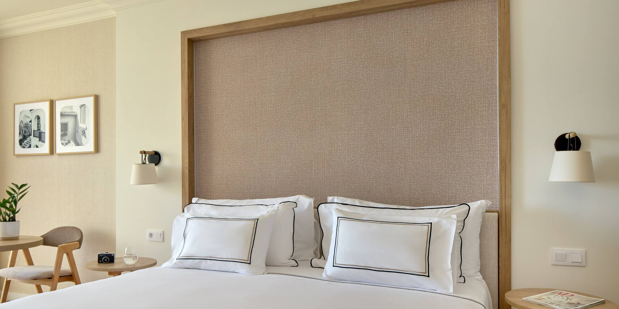 a bed with white sheets and pillows