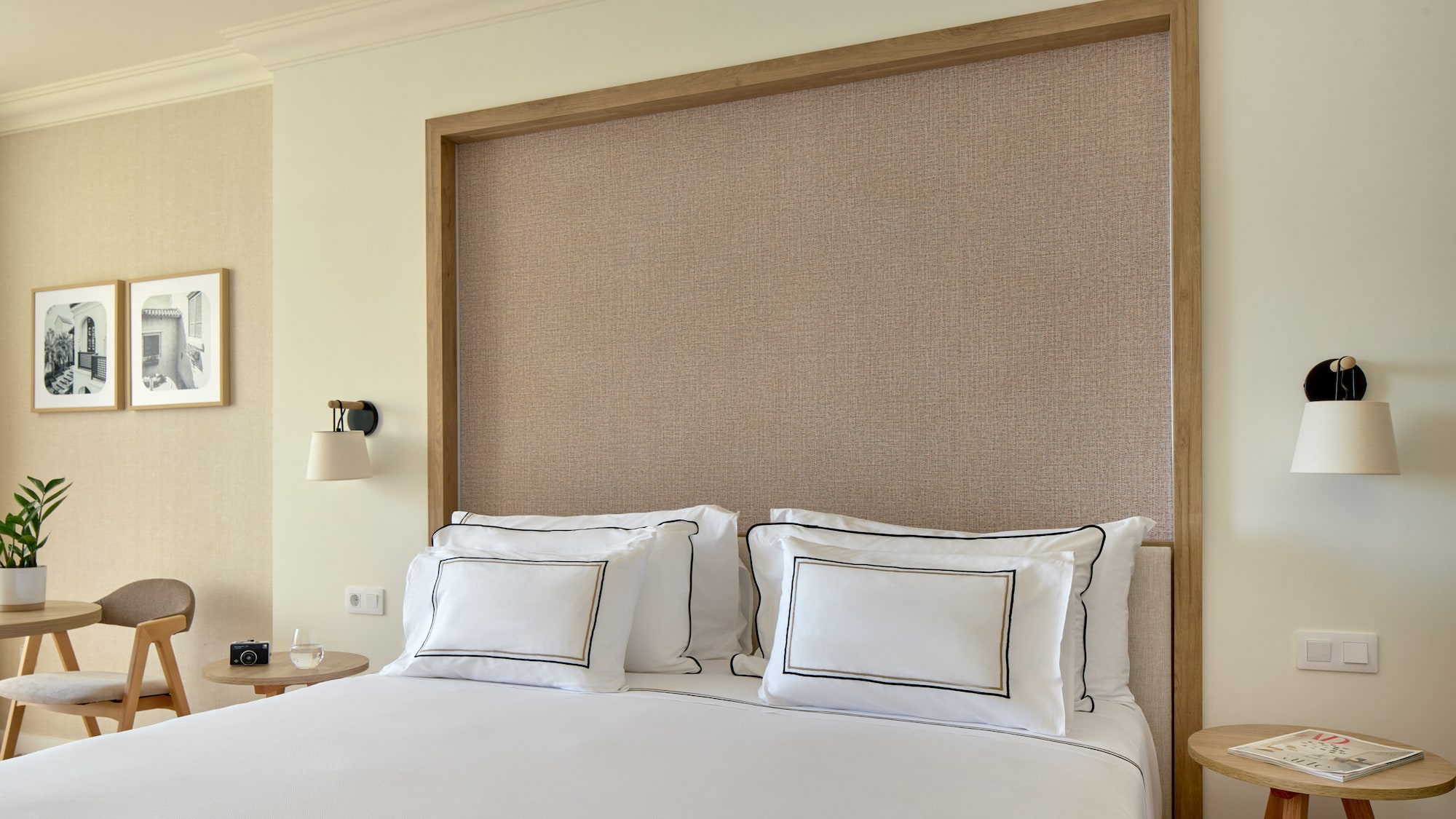 a bed with white sheets and pillows