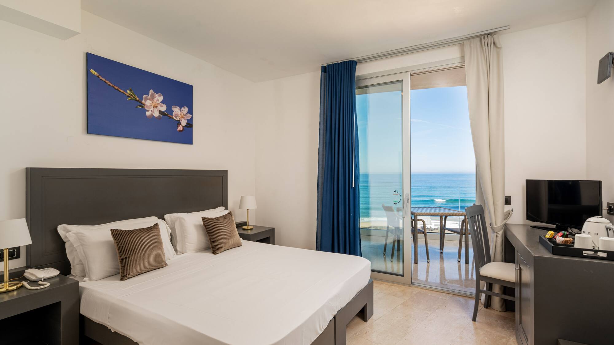 a bedroom with a glass door and a bed